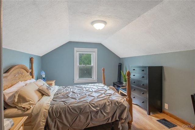 229 Brookfield Rd, Salina, NY 13211 - bedroom with light wood-type flooring, a textured ceiling, and vaulted ceiling