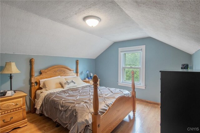 229 Brookfield Rd, Salina, NY 13211 - bedroom with wood finished floors, a textured ceiling, and lofted ceiling