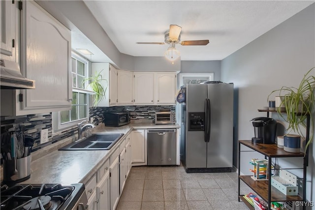 229 Brookfield Rd, Salina, NY 13211 - kitchen with appliances with stainless steel finishes, a sink, under cabinet range hood, backsplash, and granite tiled floors