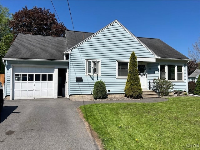 105 Woodland Dr, Cicero, NY 13212 - view of front of home featuring an attached garage, asphalt driveway, a front lawn, and a shingled roof
