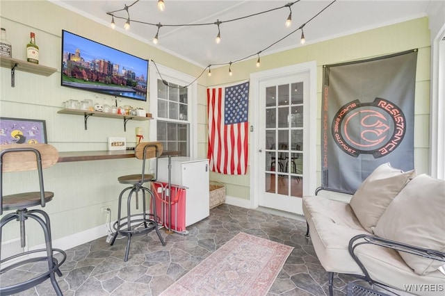 5024 Callan Dr, Lewiston, NY 14092 - living area featuring crown molding, stone floors, a bar, and baseboards