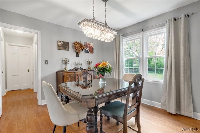 5024 Callan Dr, Lewiston, NY 14092 - dining room with a chandelier, baseboards, and light wood-style floors