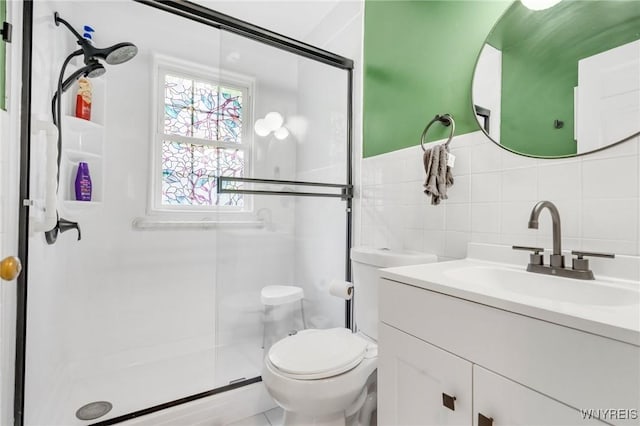5024 Callan Dr, Lewiston, NY 14092 - bathroom featuring a shower stall, vanity, toilet, tile walls, and backsplash