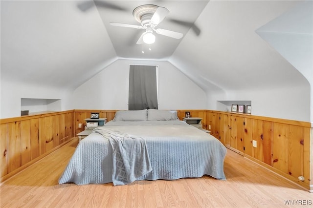 5024 Callan Dr, Lewiston, NY 14092 - bedroom with wood finished floors, a wainscoted wall, vaulted ceiling, and a ceiling fan