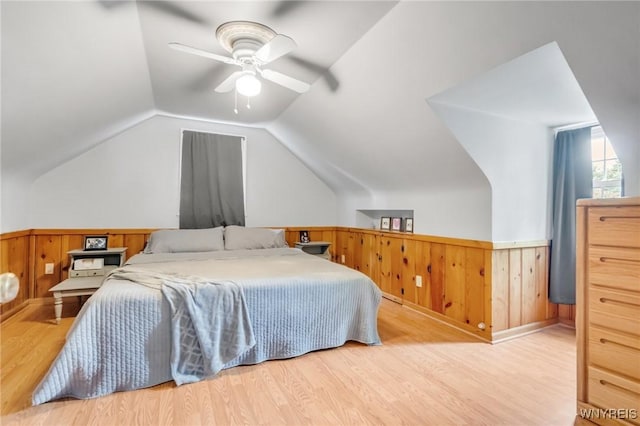 5024 Callan Dr, Lewiston, NY 14092 - bedroom with wood finished floors, a wainscoted wall, lofted ceiling, wood walls, and ceiling fan