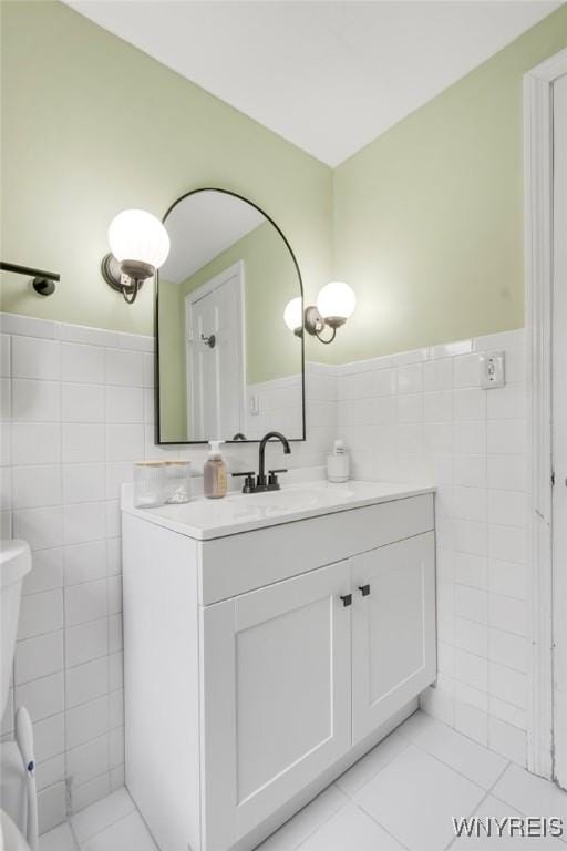 5024 Callan Dr, Lewiston, NY 14092 - bathroom featuring tile walls, vanity, toilet, a wainscoted wall, and tile patterned floors