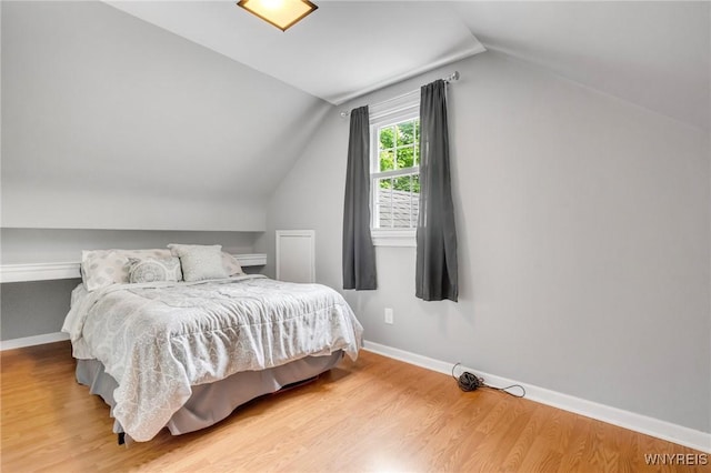 5024 Callan Dr, Lewiston, NY 14092 - bedroom featuring lofted ceiling, wood finished floors, and baseboards