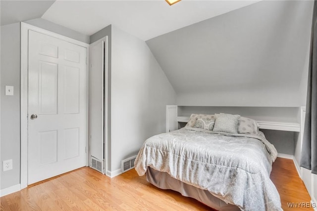 5024 Callan Dr, Lewiston, NY 14092 - bedroom with lofted ceiling, wood finished floors, and baseboards