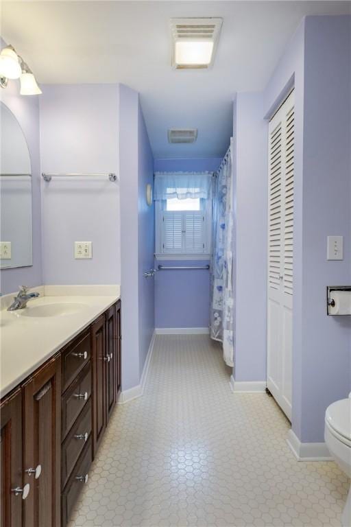61 Brookside Cir, Big Flats, NY 14903 - bathroom featuring vanity, toilet, and baseboards