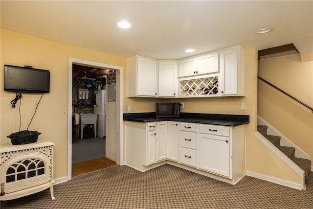 61 Brookside Cir, Big Flats, NY 14903 - kitchen with carpet floors, white cabinets, dark countertops, freestanding refrigerator, and recessed lighting