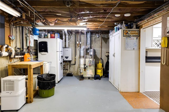 61 Brookside Cir, Big Flats, NY 14903 - unfinished basement featuring a heating unit, freestanding refrigerator, water heater, and a workshop area