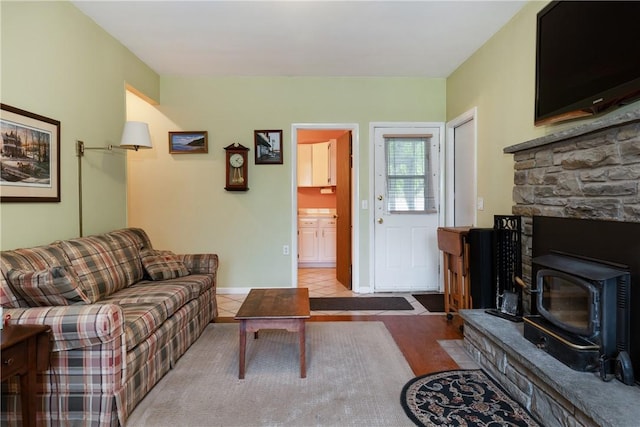 61 Brookside Cir, Big Flats, NY 14903 - living area with a wood stove and baseboards