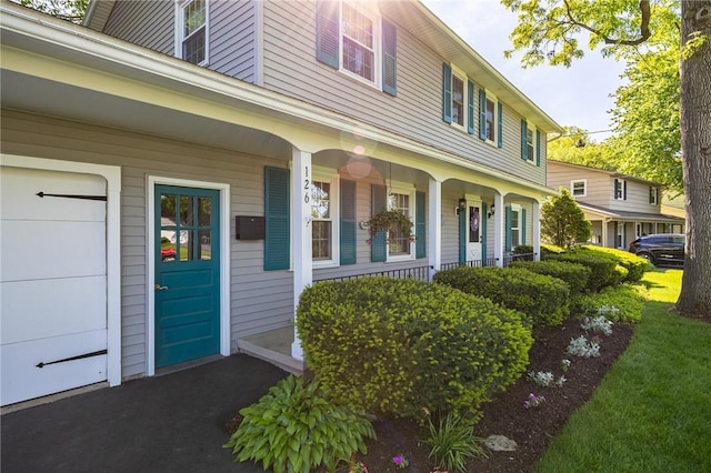 126 True Hickory Dr, Greece, NY 14615 - doorway to property with a porch and a garage