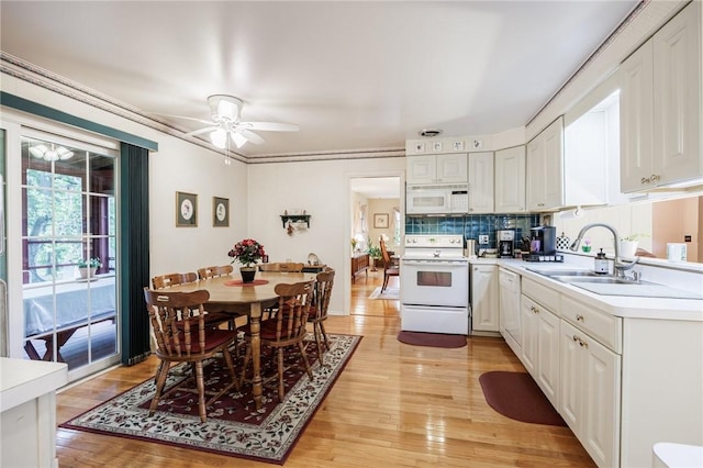 126 True Hickory Dr, Greece, NY 14615 - kitchen with white appliances, white cabinets, light countertops, a sink, and light wood-style flooring