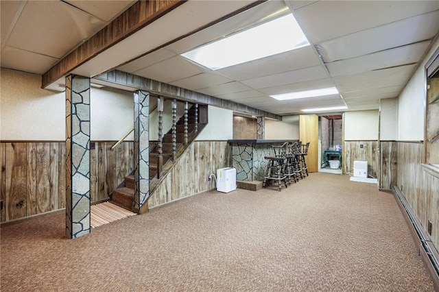 126 True Hickory Dr, Greece, NY 14615 - finished below grade area with a bar, a baseboard radiator, carpet, wood walls, and a drop ceiling