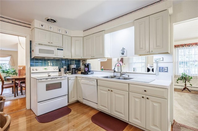 126 True Hickory Dr, Greece, NY 14615 - kitchen featuring white appliances, a sink, light countertops, light wood-type flooring, and white cabinetry