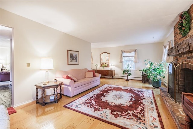 126 True Hickory Dr, Greece, NY 14615 - living area with wood finished floors, a brick fireplace, baseboards, and a baseboard radiator