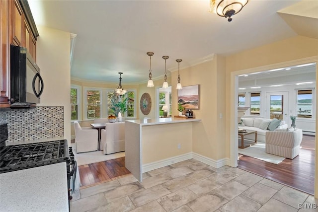 97 Burtis Point Rd, Owasco, NY 13021 - kitchen with black gas range oven, light countertops, decorative light fixtures, brown cabinetry, and open floor plan