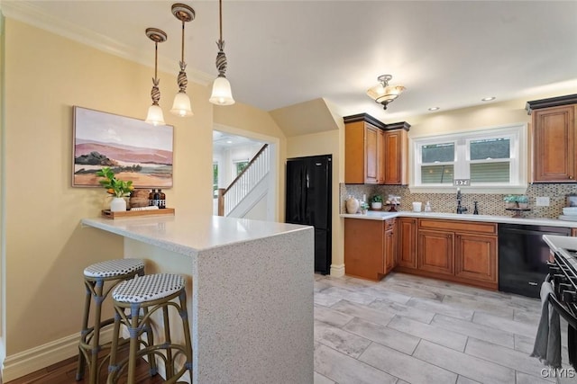 97 Burtis Point Rd, Owasco, NY 13021 - kitchen featuring black appliances, tasteful backsplash, brown cabinetry, a peninsula, and a kitchen bar