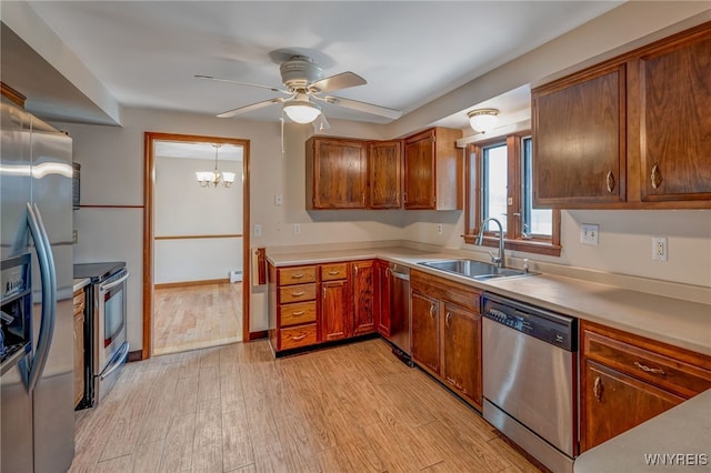 7415 Colonial Dr, Niagara, NY 14305 - kitchen featuring appliances with stainless steel finishes, a sink, ceiling fan, light wood-style flooring, and light countertops