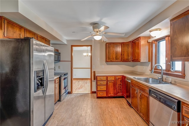 7415 Colonial Dr, Niagara, NY 14305 - kitchen featuring stainless steel appliances, a sink, ceiling fan, light wood-style flooring, and light countertops