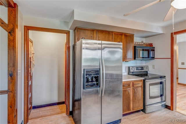 7415 Colonial Dr, Niagara, NY 14305 - kitchen with stainless steel appliances, light wood-style flooring, brown cabinetry, a ceiling fan, and baseboards