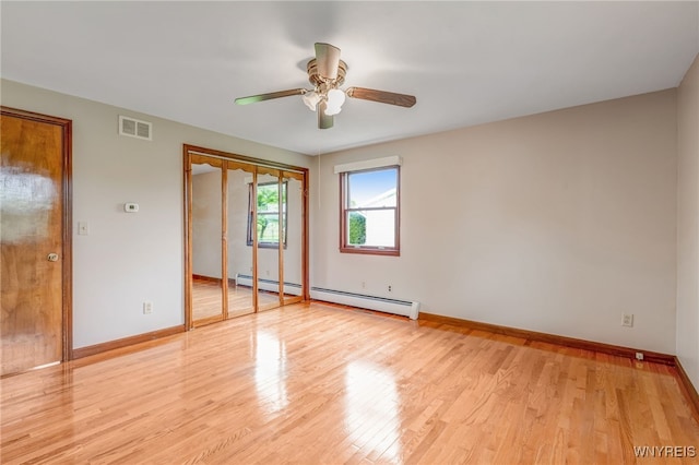 7415 Colonial Dr, Niagara, NY 14305 - unfurnished bedroom with a baseboard radiator, light wood-style flooring, baseboards, and a ceiling fan