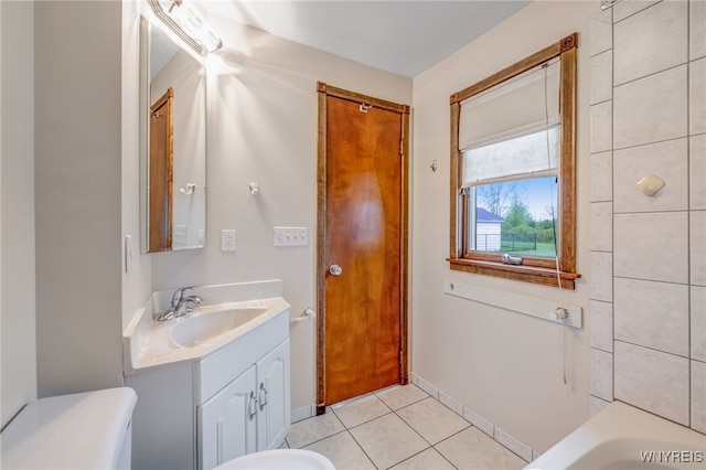 7415 Colonial Dr, Niagara, NY 14305 - full bath featuring vanity, toilet, tile patterned flooring, a bath, and baseboards