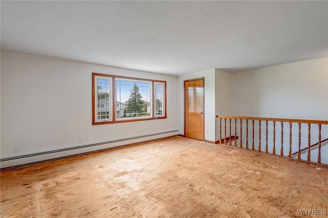 7415 Colonial Dr, Niagara, NY 14305 - empty room with a baseboard heating unit and a textured ceiling