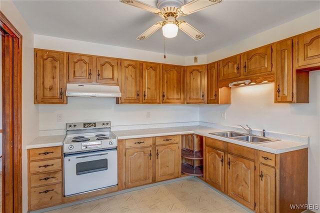 7415 Colonial Dr, Niagara, NY 14305 - kitchen with white range with electric cooktop, under cabinet range hood, a sink, brown cabinets, and a ceiling fan