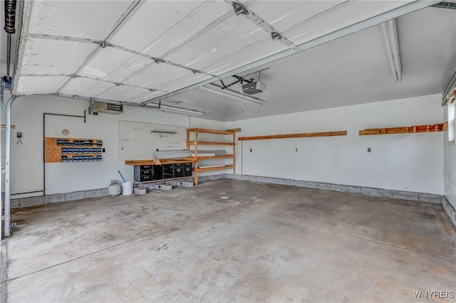 7415 Colonial Dr, Niagara, NY 14305 - garage featuring a garage door opener and a workshop area