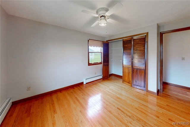 7415 Colonial Dr, Niagara, NY 14305 - unfurnished bedroom with a baseboard radiator, a closet, light wood finished floors, and baseboards
