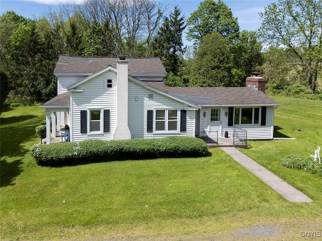 7078 Fuller Rd, Aurelius, NY 13140 - view of front of home featuring a chimney, a front lawn, and a shingled roof