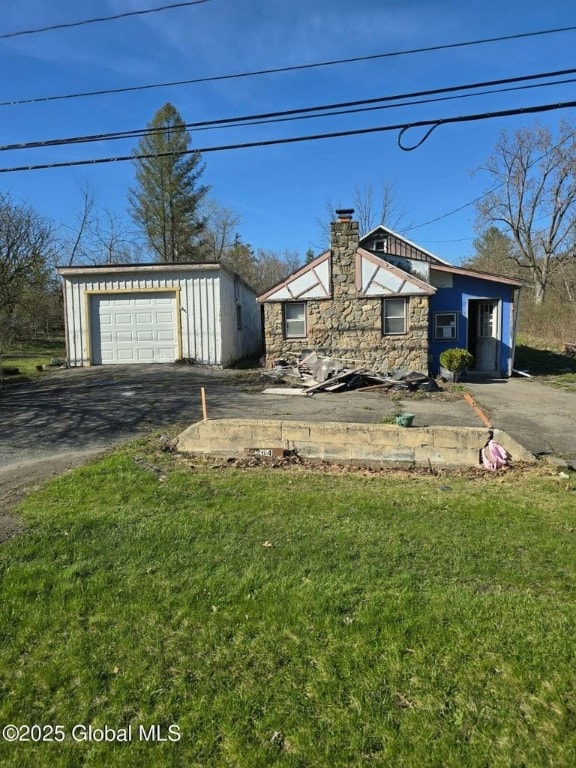 264 State Highway 5s, Florida, NY 12137 - view of front of property with a chimney, stone siding, an outbuilding, asphalt driveway, and a front lawn