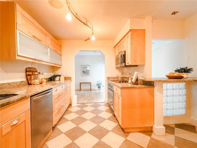 31 Overbrook Rd, Pittsford, NY 14618 - kitchen with light brown cabinets, appliances with stainless steel finishes, arched walkways, light stone countertops, and baseboards
