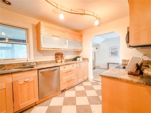 31 Overbrook Rd, Pittsford, NY 14618 - kitchen with stainless steel dishwasher, light brown cabinets, arched walkways, light stone counters, and light floors