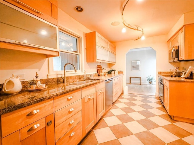 31 Overbrook Rd, Pittsford, NY 14618 - kitchen featuring a sink, stainless steel appliances, stone counters, and arched walkways