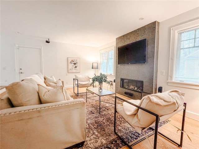 31 Overbrook Rd, Pittsford, NY 14618 - living area with baseboards, wood finished floors, a large fireplace, and plenty of natural light