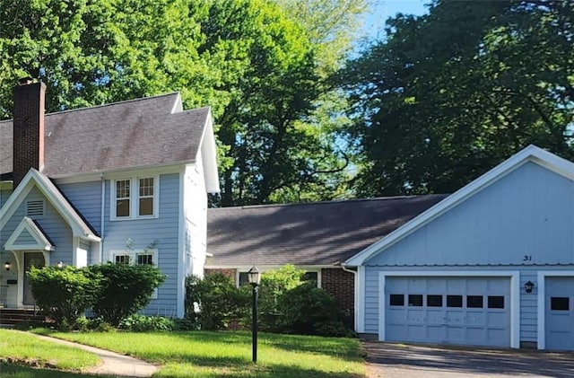 31 Overbrook Rd, Pittsford, NY 14618 - view of front of property featuring a chimney, a garage, a front yard, and roof with shingles
