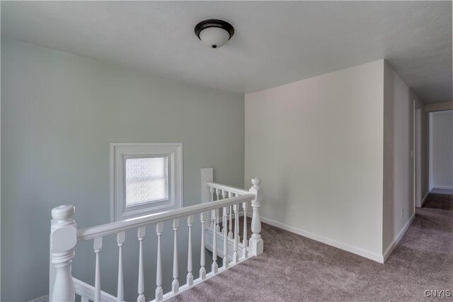 1010 Academy St, Watertown-City, NY 13601 - hall with an upstairs landing, carpet flooring, and baseboards