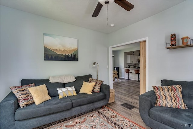 1010 Academy St, Watertown-City, NY 13601 - living area with wood finished floors, ceiling fan, and baseboards