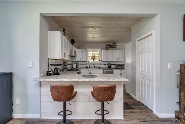 1010 Academy St, Watertown-City, NY 13601 - kitchen with dishwasher, a peninsula, light countertops, white cabinetry, and a sink