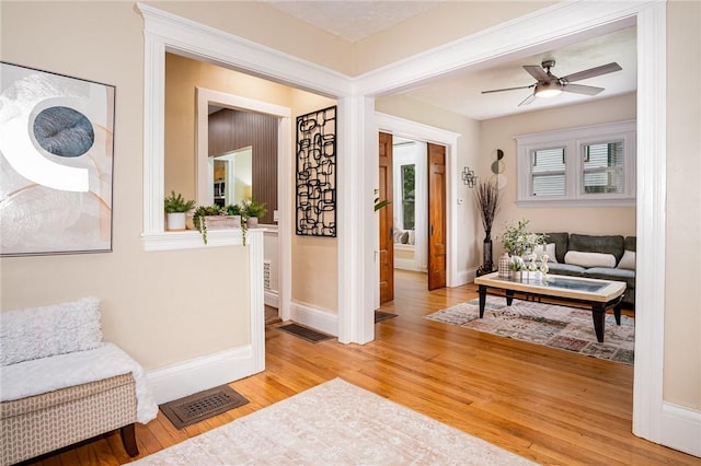 162 Post Ave, Rochester, NY 14619 - living area with light wood finished floors, baseboards, and a ceiling fan