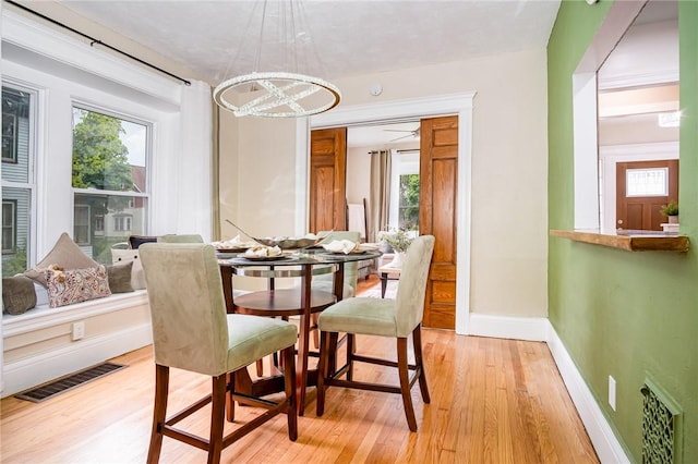 162 Post Ave, Rochester, NY 14619 - dining area featuring light wood-style floors, a chandelier, and healthy amount of natural light