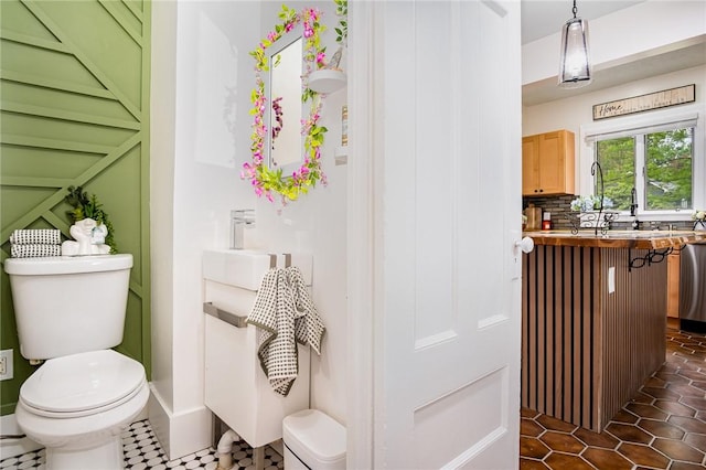 162 Post Ave, Rochester, NY 14619 - bathroom with toilet, tasteful backsplash, and tile patterned floors