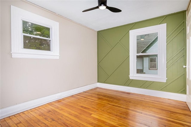 162 Post Ave, Rochester, NY 14619 - empty room with a decorative wall, ceiling fan, baseboards, and wood finished floors