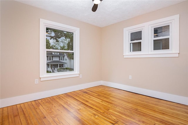 162 Post Ave, Rochester, NY 14619 - unfurnished room featuring ceiling fan, baseboards, wood finished floors, and a textured ceiling