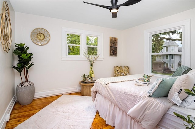 162 Post Ave, Rochester, NY 14619 - bedroom featuring multiple windows, light wood finished floors, and baseboards