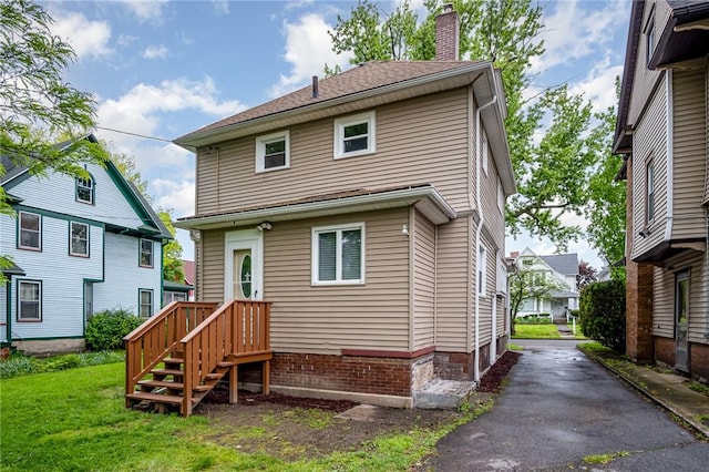 162 Post Ave, Rochester, NY 14619 - rear view of property with a chimney and a lawn