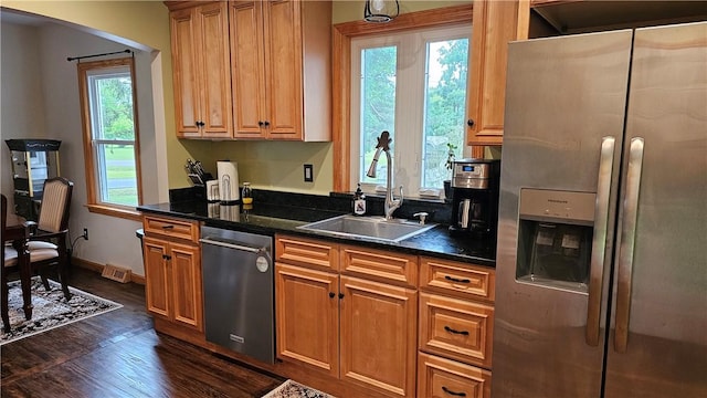 5267 Wheeler Rd, Elbridge, NY 13166 - kitchen with appliances with stainless steel finishes, a sink, dark wood-type flooring, arched walkways, and brown cabinets